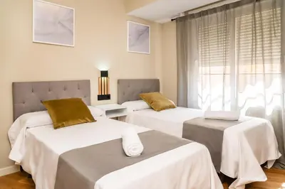 a room with three beds and a window at El Labrador in Anna