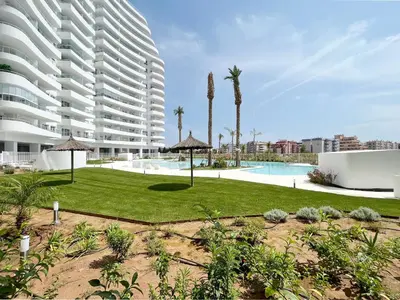 a large apartment building with a lawn and a swimming pool at Global Vacacional, Apartamento para 5 personas con terraza in Canet de Berenguer