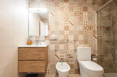 a bathroom with a toilet and a sink at El Mosaico Apartment in Valencia