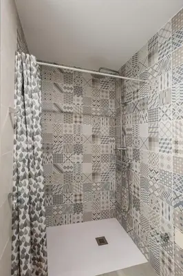 a bathroom with a shower with a shower curtain at El Mosaico Apartment in Valencia