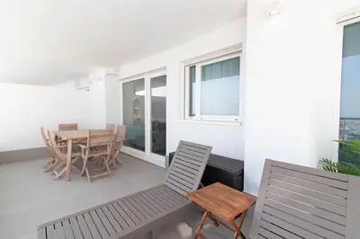 a balcony with a table and chairs and a table and chairs at Global Vacacional, Apartamento con terraza y vistas a la costa mediterránea in Canet de Berenguer