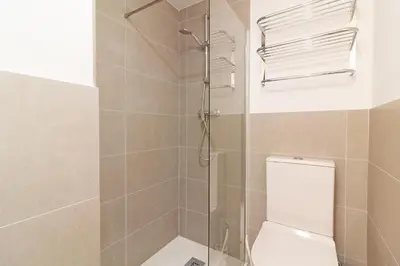 a bathroom with a glass shower with a toilet at Global Vacacional, Apartamento con terraza y vistas a la costa mediterránea in Canet de Berenguer