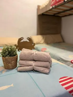 a pile of towels on a table next to a bed at Casa en primera linea de playa in Puzol