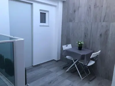 a table and chairs in a room with a wall at Urban Beach in Valencia