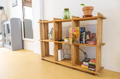 a wooden book shelf in a room with books at Maritime House Valencia Beach in Valencia