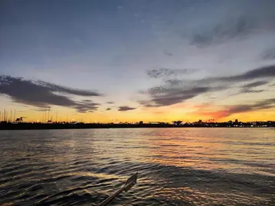 a boat in a body of water with a sunset at Villa near Valencia with Private Pool in Valencia