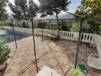a pergola and a bench on a patio at Villa near Valencia with Private Pool in Valencia