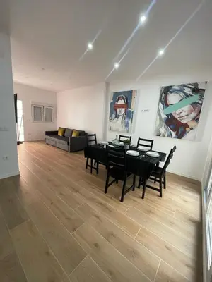 a living room with a table and chairs and a couch at UIM Mediterraneo CASA Sepulveda Wifi in Puerto de Sagunto