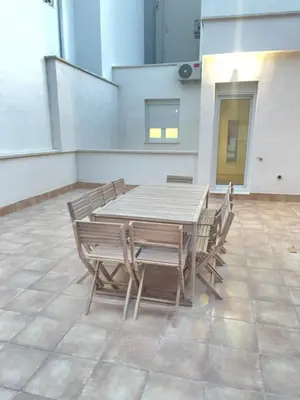 a wooden table and chairs on a patio at UIM Mediterraneo CASA Sepulveda Wifi in Puerto de Sagunto