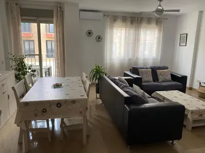 a living room with a couch and a table at Apartamento San Vicente in Villar del Arzobispo