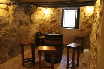 a room with a barrel and tables and a window at Alojamiento turistico LaVid in Requena