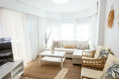 a white living room with a couch and a table at Almar Collection Cullera AT in Cullera