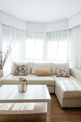 a white living room with a couch and a table at Almar Collection Cullera AT in Cullera