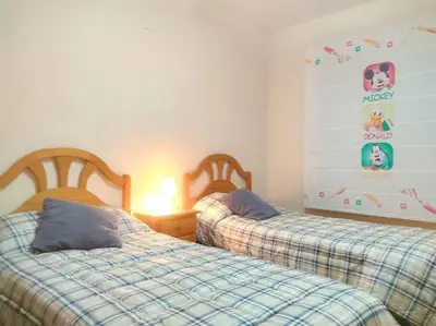 two beds sitting next to each other in a bedroom at Precioso apartamento en Puerto de Sagunto Valencia in Puerto de Sagunto