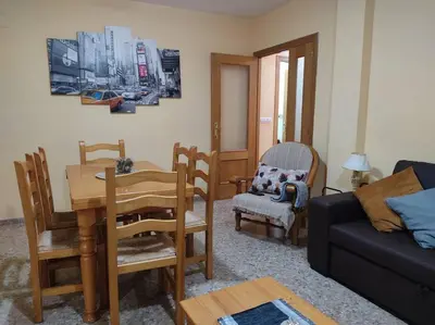 a living room with a table and chairs and a couch at Precioso apartamento en Puerto de Sagunto Valencia in Puerto de Sagunto
