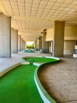 a large building with a green lawn in the middle at Blue Beach Apartment+Oceanview+Private Parking in Valencia