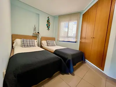 a bedroom with two beds and a window at Blue Beach Apartment+Oceanview+Private Parking in Valencia
