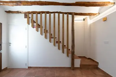 a staircase in a house with wooden beams at Casa Rural Lavadero en Teresa in Ríos de Abajo