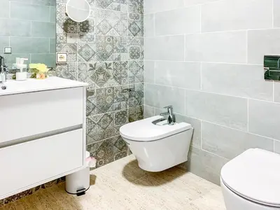 a bathroom with a toilet and a sink at ESPACIO 15 - Primera Línea de Playa in Cullera
