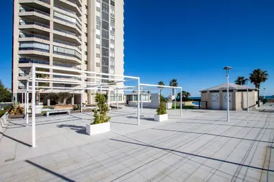 a large plaza in front of a tall building at ESPACIO 15 - Primera Línea de Playa in Cullera