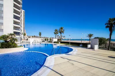 a swimming pool with the ocean in the background at ESPACIO 8 - Primera Línea de Playa in Cullera