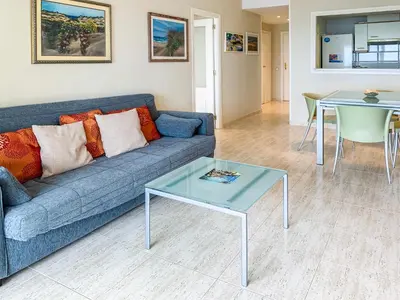 a living room with a blue couch and a table at ESPACIO 8 - Primera Línea de Playa in Cullera