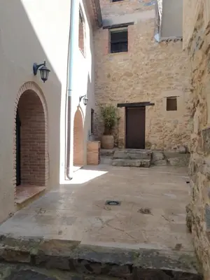 an alley in an old stone building with a door at Casa Rural Mirador de la Torre in Alcublas