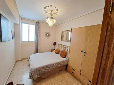 a bedroom with a bed and a chandelier at 3 bedroom Flat with WiFi in Valencia