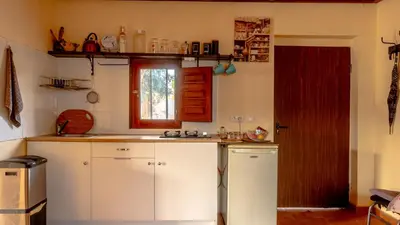 a small kitchen with white cabinets and a window at Orange Blossom Finca Unique in Valencia