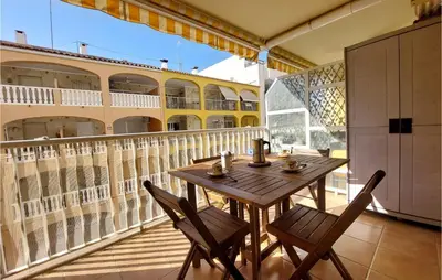 a patio with a table and chairs on a balcony at Gorgeous Apartment In Playa De Moncofa in Moncófar