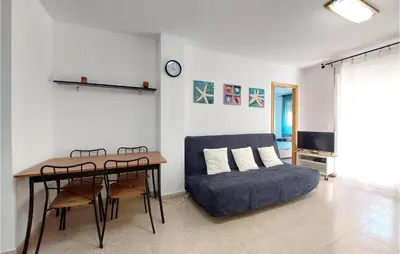 a living room with a couch and a table at Gorgeous Apartment In Playa De Moncofa in Moncófar