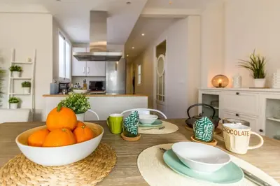 a kitchen with a table with a bowl of oranges on it at Gran Vía by District Key in Valencia