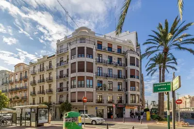a large building on the corner of a street at Gran Vía by District Key in Valencia