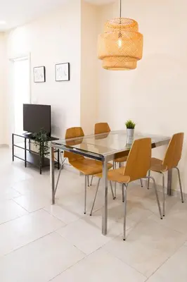 a dining room with a glass table and chairs at Nest Silence in Valencia