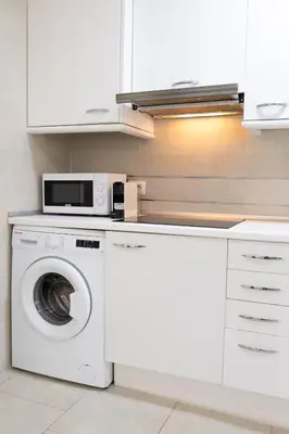 a kitchen with a washing machine and a microwave at Nest Silence in Valencia