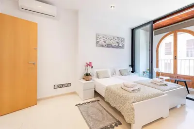 a bedroom with two beds and a large window at Grand Villa Valencia - 8 min to Center by Metro in Valencia