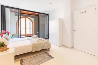 a bedroom with a bed and a large window at Grand Villa Valencia - 8 min to Center by Metro in Valencia