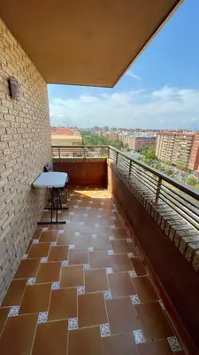 a balcony with a table and a view of a city at flat Holiday friend group or family near beach center blasco ibanez in Valencia