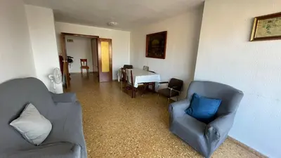 a living room with two chairs and a table at flat Holiday friend group or family near beach center blasco ibanez in Valencia