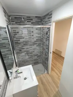 a bathroom with a sink and a glass shower at Entre montañas in Dos Aguas