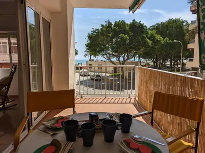 a table with a view of the ocean from a balcony at Terraza con vistas al mar Parking privado 120 mts, junto a la playa in Cullera