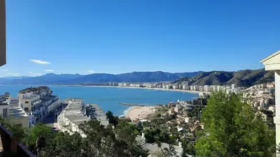 a view of a city with a beach and buildings at Terraza con vistas al mar Parking privado 120 mts, junto a la playa in Cullera