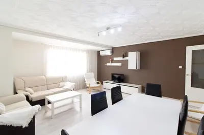 a living room with a couch and a table at Global Vacacional, Apartamento de 4 habitaciones a 100 m de la playa in Puerto de Sagunto