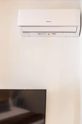 a white microwave oven sitting on top of a refrigerator at FLORIT FLATS - The Green Apartments in Valencia