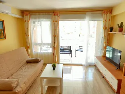 a living room with a couch and a tv at Sea view apartment in Cullera