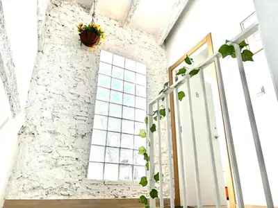 a staircase with a window and a plant on the wall at Loft B El Ramellet in Alginet