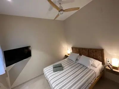 a bedroom with a bed and a flat screen tv at Bali style Ruzafa in Valencia